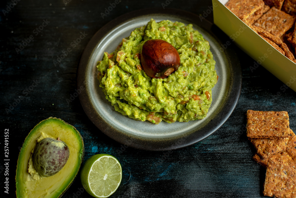 green, naturally made traditional guacamole surrounded by fresh ingredients and nachos green, naturally made traditional guacamole surrounded by fresh ingredients and nachos