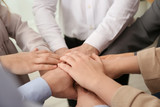 Group of people holding their hands together, closeup