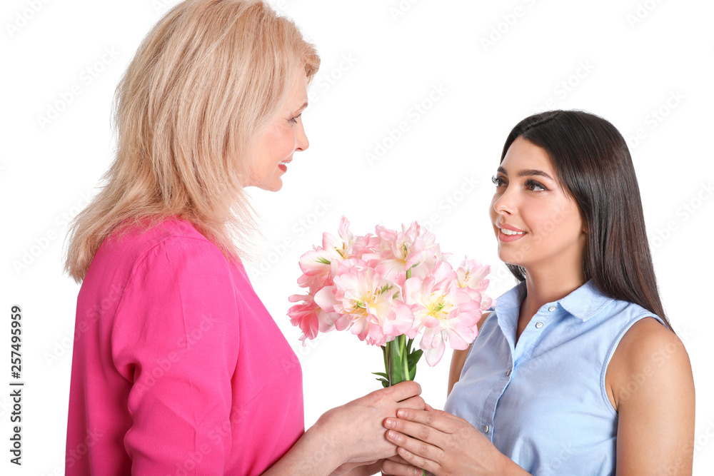 Young woman congratulating her mature mom on white background. Happy Mother's Day