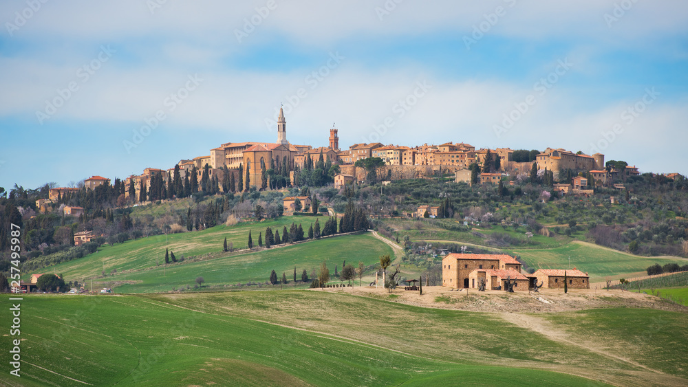 Hills of meadows below the medieval village of Pienza in Tuscany