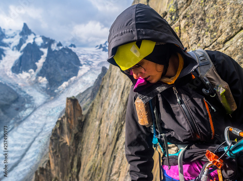 Female rock climber looking down in French Alps, Aiguille du Grepon, Haute-Savoie, France photo