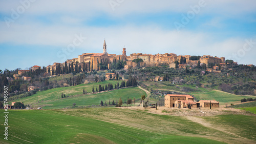 Hills of meadows below the medieval village of Pienza in Tuscany photo