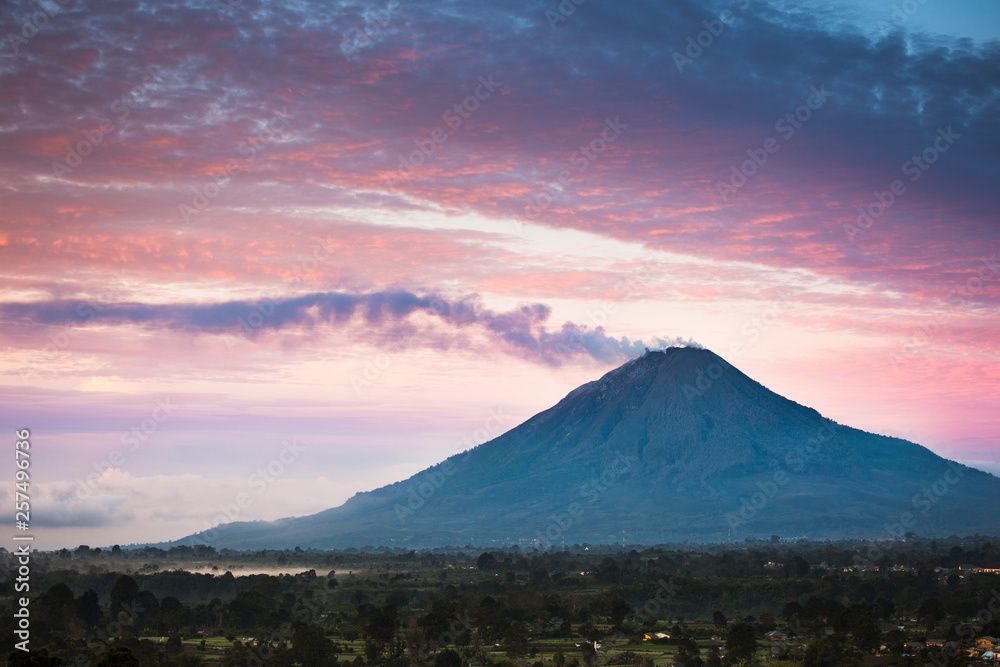 Steam coming from Mount Sinabung (Gunung Sinabung) at sunrise. Steam coming from Mount Sinabung (Gunung Sinabung) at sunrise.
