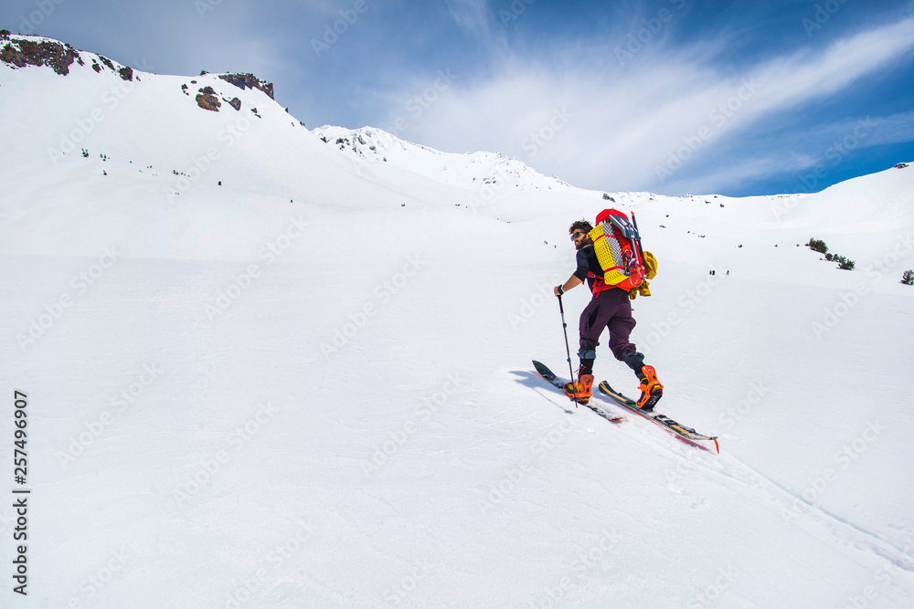 Man cross country skiing towards Mt Shasta, California, USA Man cross country skiing towards Mt Shasta, California, USA