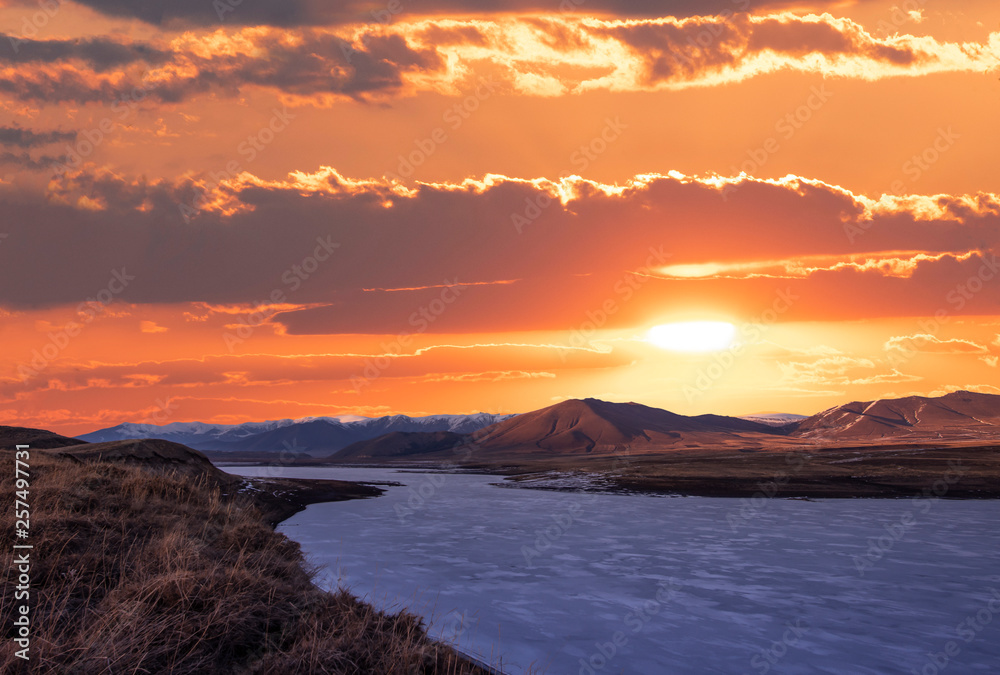 Beautiful sunset over mountains and frozen lake. Beautiful sunset over mountains and frozen lake.