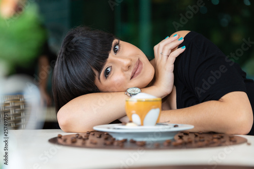 Woman drinking coffee table. Women in cafe.