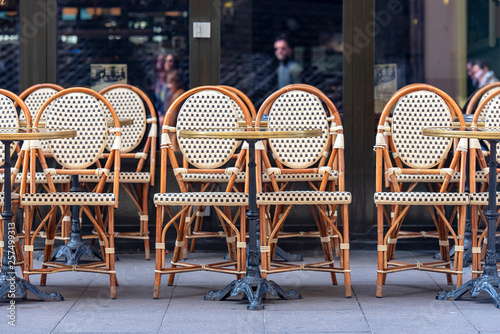 Fototapet Rows of traditional Chairs of a Street Cafe in France, french furniture in a Str