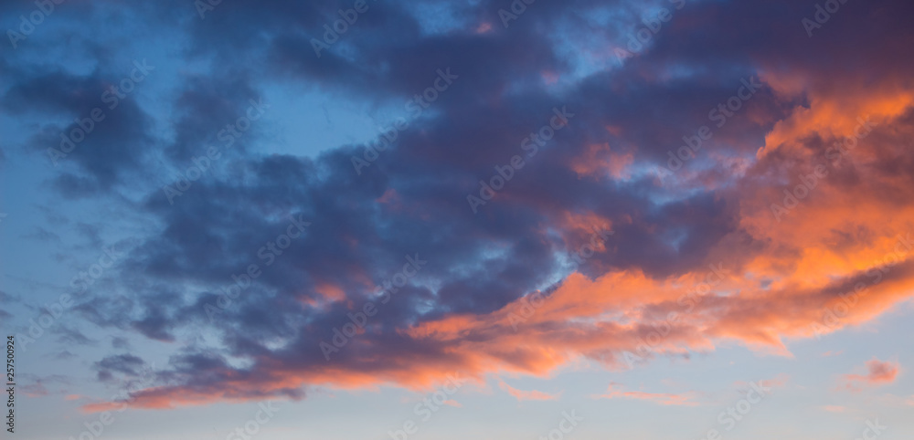 Blue and orange clouds in the sky during the sunset. Evening sky_