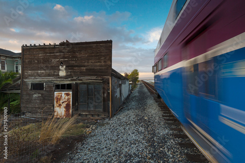 Train passing by old building, Alviso, California, USA photo