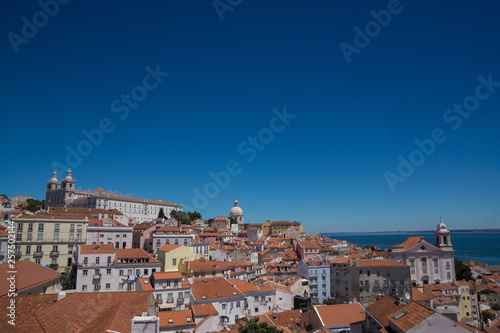 many houses red roofs and blue sky