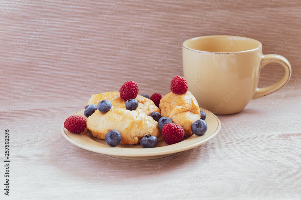 fresh juicy summer berries raspberry and blueberry with drops of honey in a natural beige cotton cloth. fresh juicy summer berries raspberry and blueberry with drops of honey in a natural beige cotton cloth.