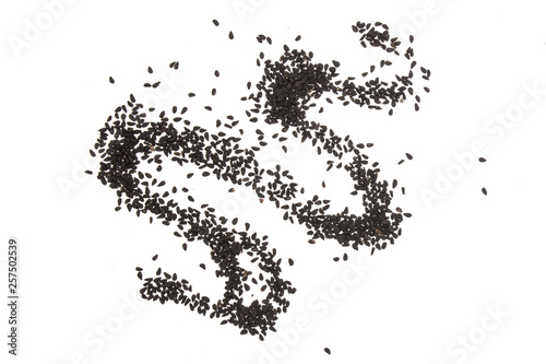 Lot of whole waving line black cumin seeds flatlay isolated on white background