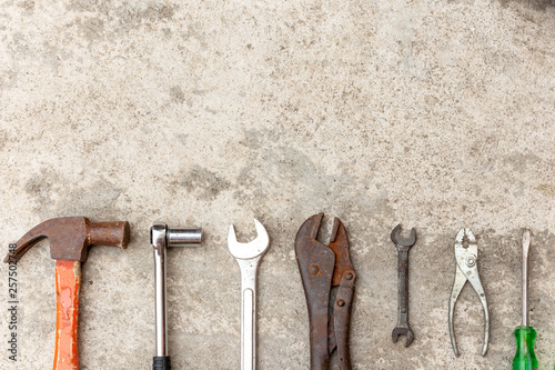 Many carftsman tools that are placed on the cement floor.