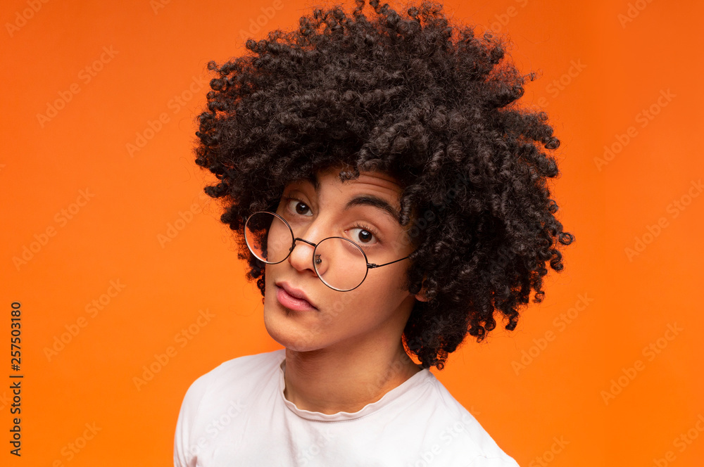 Funny black guy looking doubtfully at camera