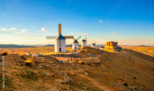 Spanish windmills and medieval castle on a hill in Consuegra, Toledo, Spain. photo