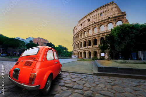 Photography Old car in the background of the Colosseum in Rome