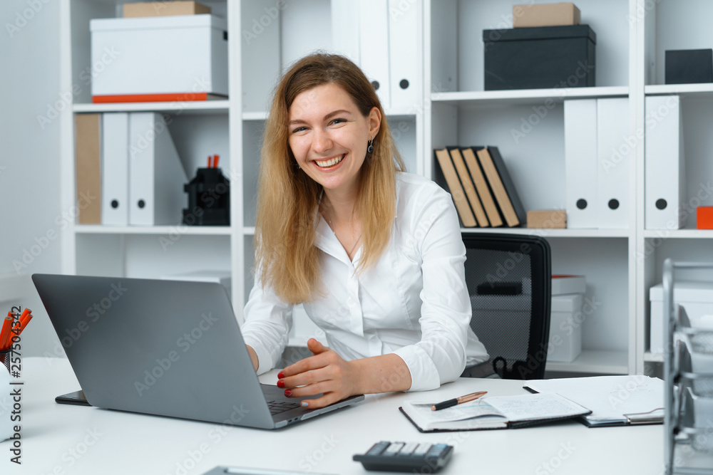 pretty blond young woman serfing the internet use laptop sit at table in office pretty blond young woman serfing the internet use laptop sit at table in office
