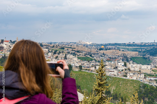 Woman taking photograph with smartphone at enjoying view of Jerusalem Photograph on the phone Old City of Jerusalem.