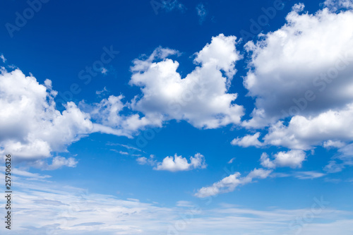 Cloudscape. Blue sky with large white clouds. Beautiful big clouds slowly float against the blue sky.