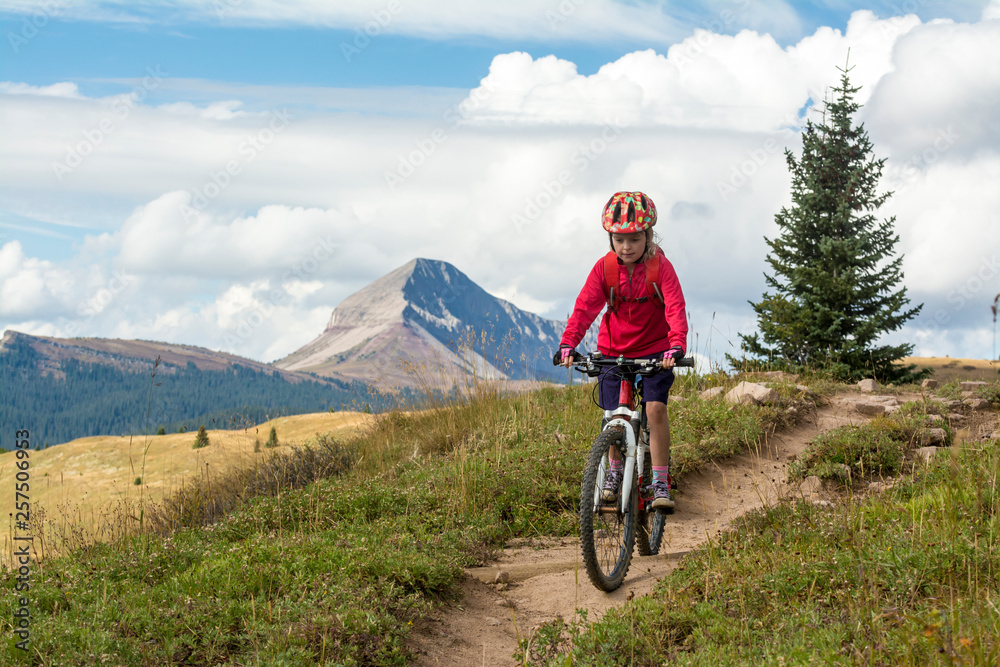 A young girl mountain biking in the San Juan National Forest, Silverton, Colorado. A young girl mountain biking in the San Juan National Forest, Silverton, Colorado.