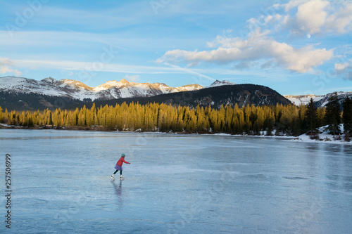 A girl ice skating on Molas Lake, San Juan National Forest, Silverton, Colorado. photo