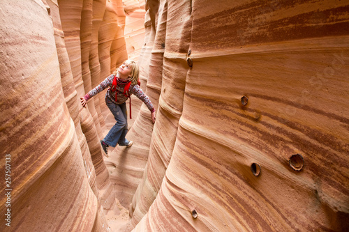 A young girl hiking through sandstone canyon near Escalante, Utah. photo