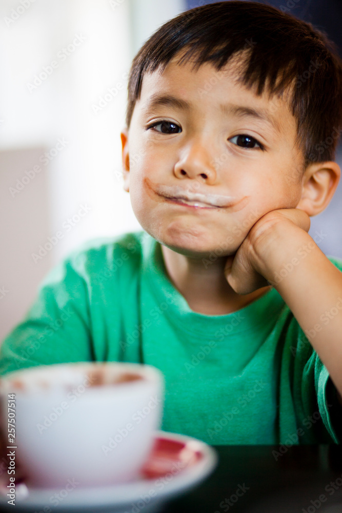 A Japanese American four year old boy drinks a craft hot chocolate. A Japanese American four year old boy drinks a craft hot chocolate.