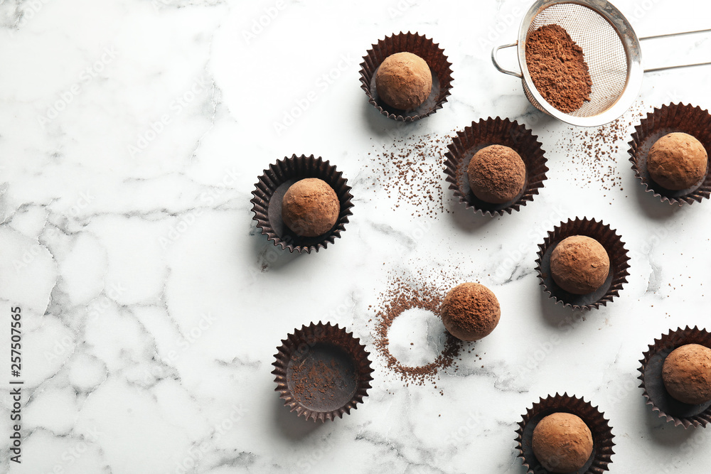 Flat lay composition with tasty raw chocolate truffles on marble background, space for text Flat lay composition with tasty raw chocolate truffles on marble background, space for text