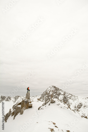 A man stading on granite spire in Little Cottonwood Canyon, Salt Lake City, Utah.