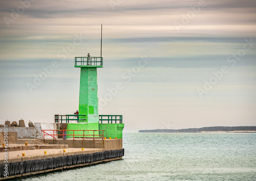 Green lighthouse at the entrance to the harbour