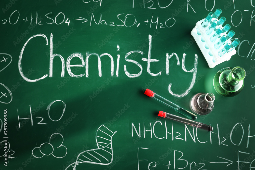 Flat lay composition with laboratory glassware on chalkboard. Chemistry concept Flat lay composition with laboratory glassware on chalkboard. Chemistry concept