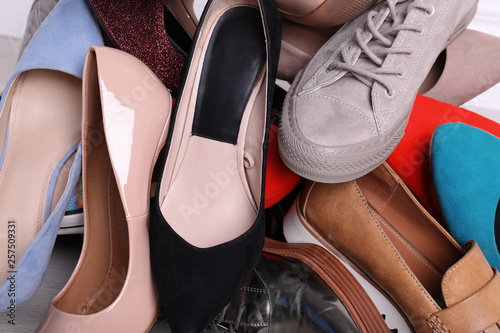 Large heap of different modern shoes, closeup