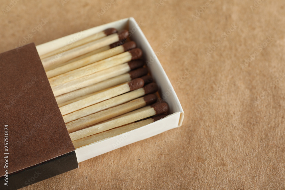 Open box with matches on craft paper, space for text Open box with matches on craft paper, space for text
