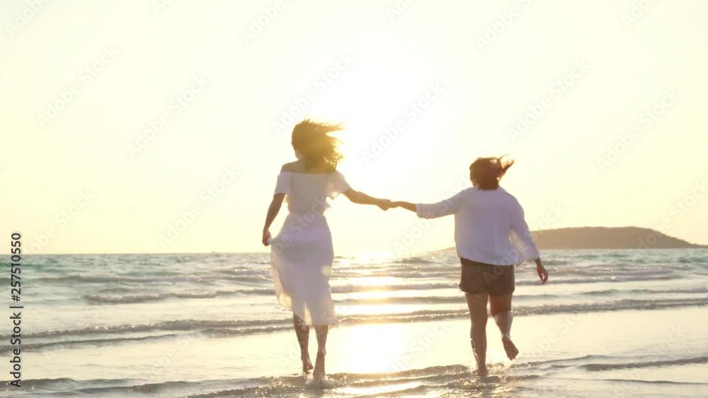 Young Asian lesbian couple running on beach. Beautiful women friends happy relax having fun on beach near sea when sunset in evening. Lifestyle lesbian couple travel on beach concept. Young Asian lesbian couple running on beach. Beautiful women friends happy relax having fun on beach near sea when sunset in evening. Lifestyle lesbian couple travel on beach concept.