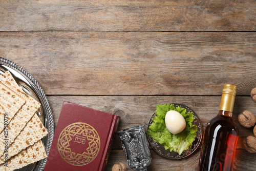 Flat lay composition with symbolic Passover (Pesach) items on wooden background, space for text photo