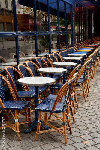 Street Cafe with empty tables and chairs on street in Paris, France