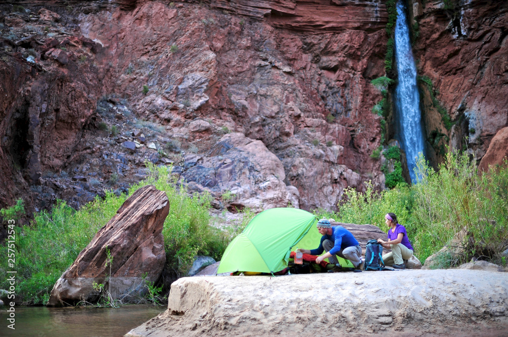 Hikers setup camp on a beach along the Colorado River near the