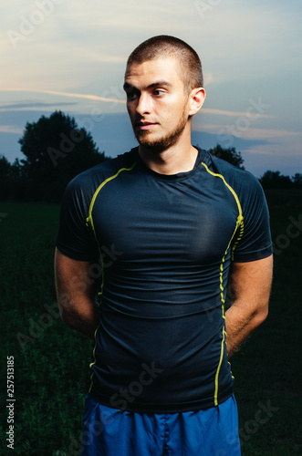 portrait of a boy in a sports Jersey. beautiful brunette at sunset