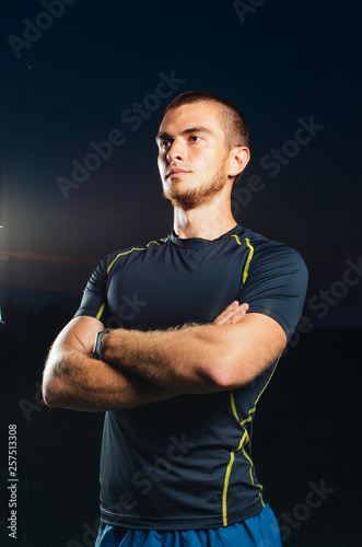 portrait of a boy in a sports Jersey. a guy with strong hands. shooting in the Park of the athlete