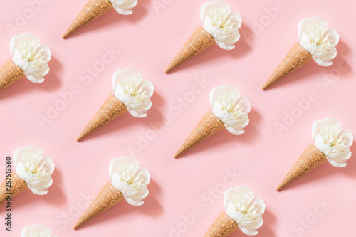 White peony flower in waffle cone on pink. Summer concept. photo