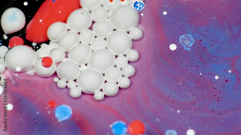 Amazing white bubbles of paint on the purple oil surface. Paint in oil. Amazing white bubbles of paint on the purple oil surface. Paint in oil.