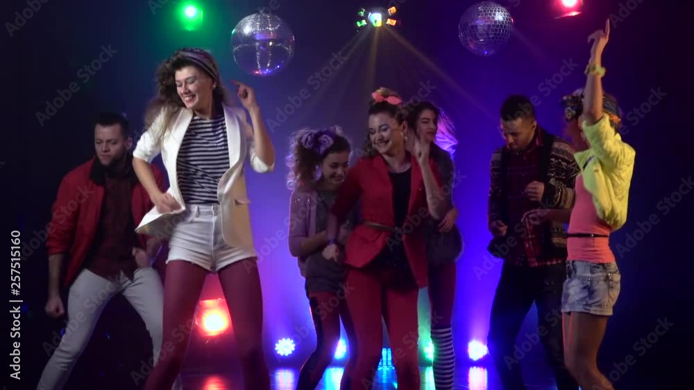 Friends dancing at a party having a night . Slow motion . Smoke background Friends dancing at a party having a night . Slow motion . Smoke background