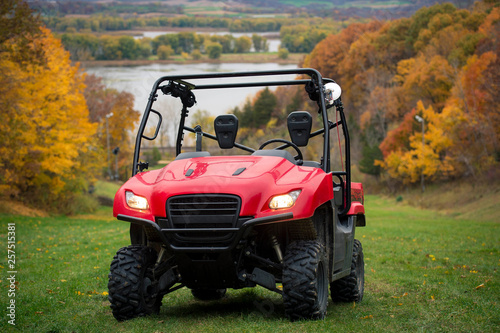 Side by side Atv vehicle on grass trail in the fall along Mississippi River photo