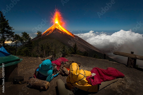 Young couple watching eruption of Fuego Volcano, Guatemala photo