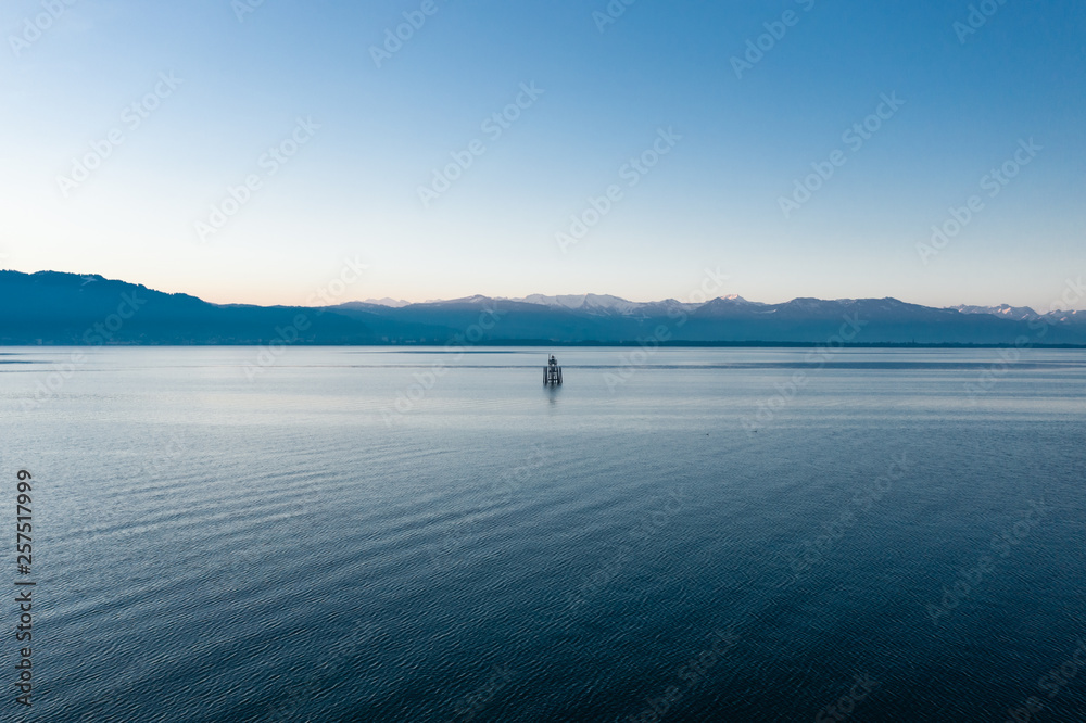 Calm panoramic view of Lake Constance with the Austrian Alps in the background, Bavaria, Germany
