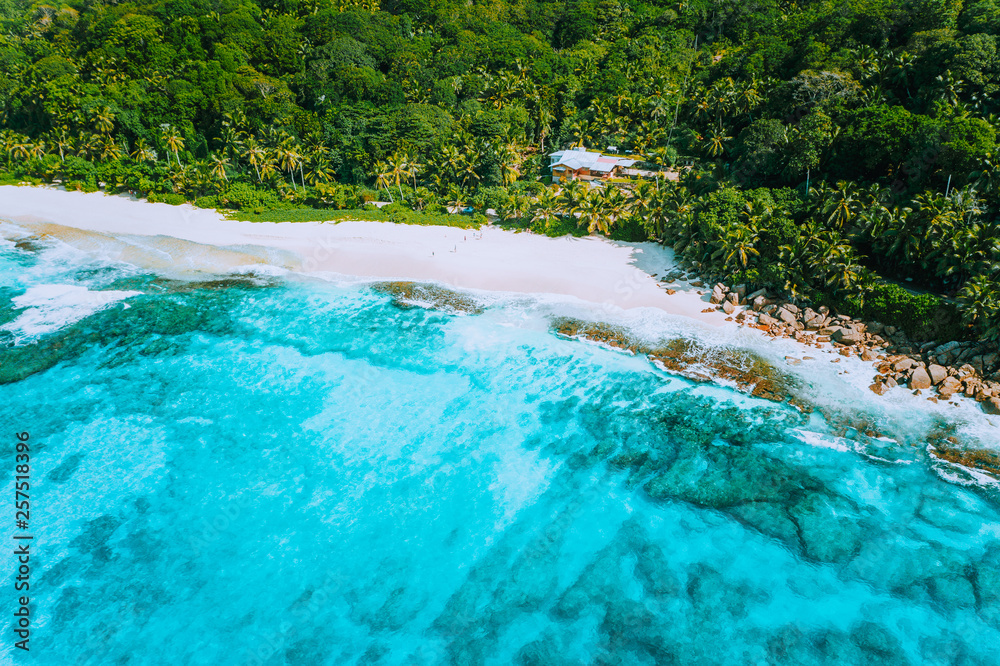 Aerial drone photo of great tropical dream beach Anse Bazarca, Mahe island, Seychelles. White powdery sand, azure water, lush vegetation, granite rocks