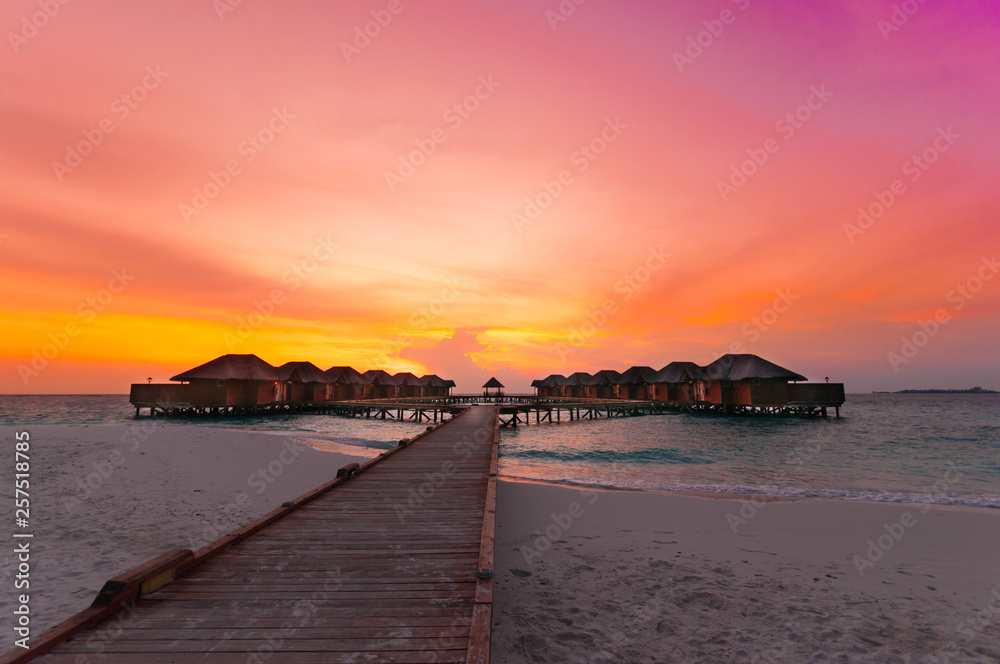 Luxury beach landscape. Exotic summer vacation background, beautiful sky and clouds at sunset at Maldives