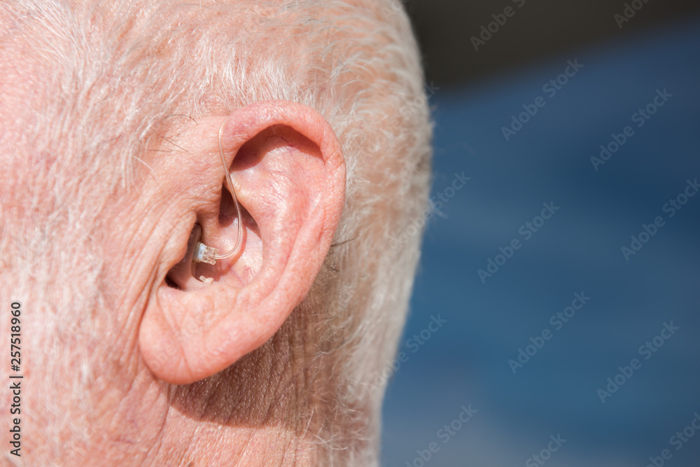 Digital modern hearing aid in the ear of senior man Digital modern hearing aid in the ear of senior man