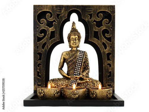Bilde på lerret Buddha sculpture with golden color in decorative frame with candles and overall