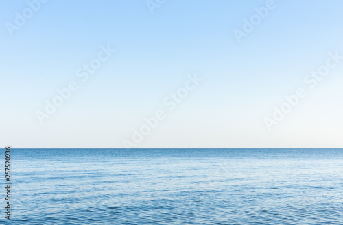 Sea background, quiet cozy calm cloudless morning on the sea coast